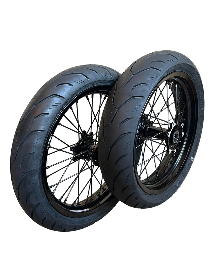 Two motorcycle wheels with black tires on a white background
