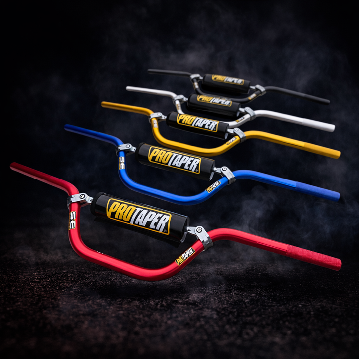 Set of ProTaper handlebars in red, blue, yellow, and black on a dark background