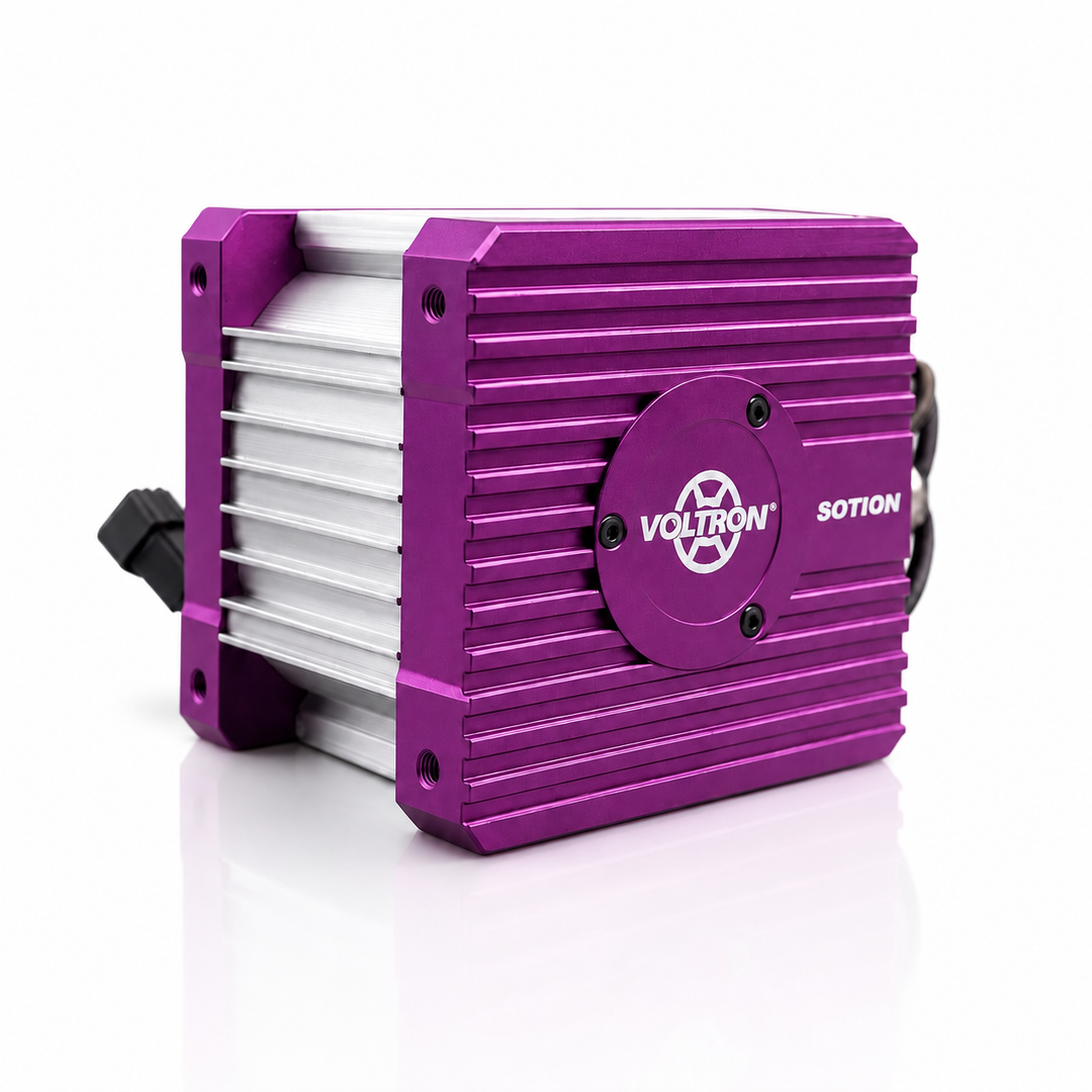 A purple and silver Voltron Sotion electronic device with a ribbed metal casing, a circular logo badge, and a black connector on the side, shown on a white reflective background.