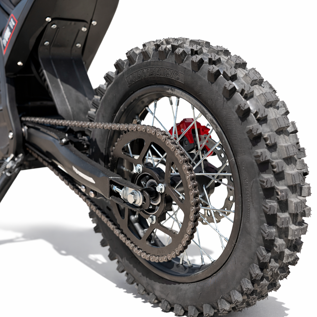 Close-up of a motorcycle tire with knobby tread pattern on a white background