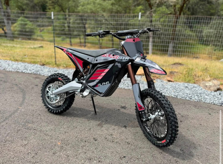 Small dirt bike on a gravel surface with a natural background