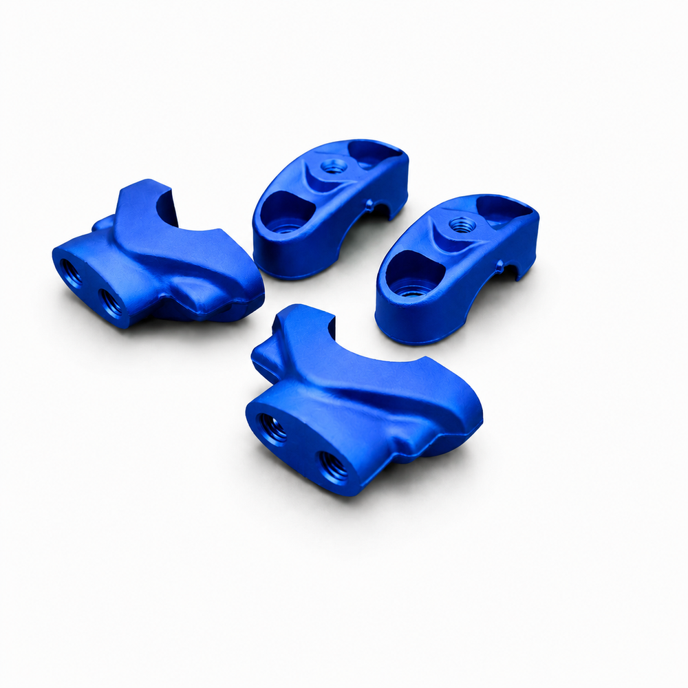 Four blue plastic components on a white background