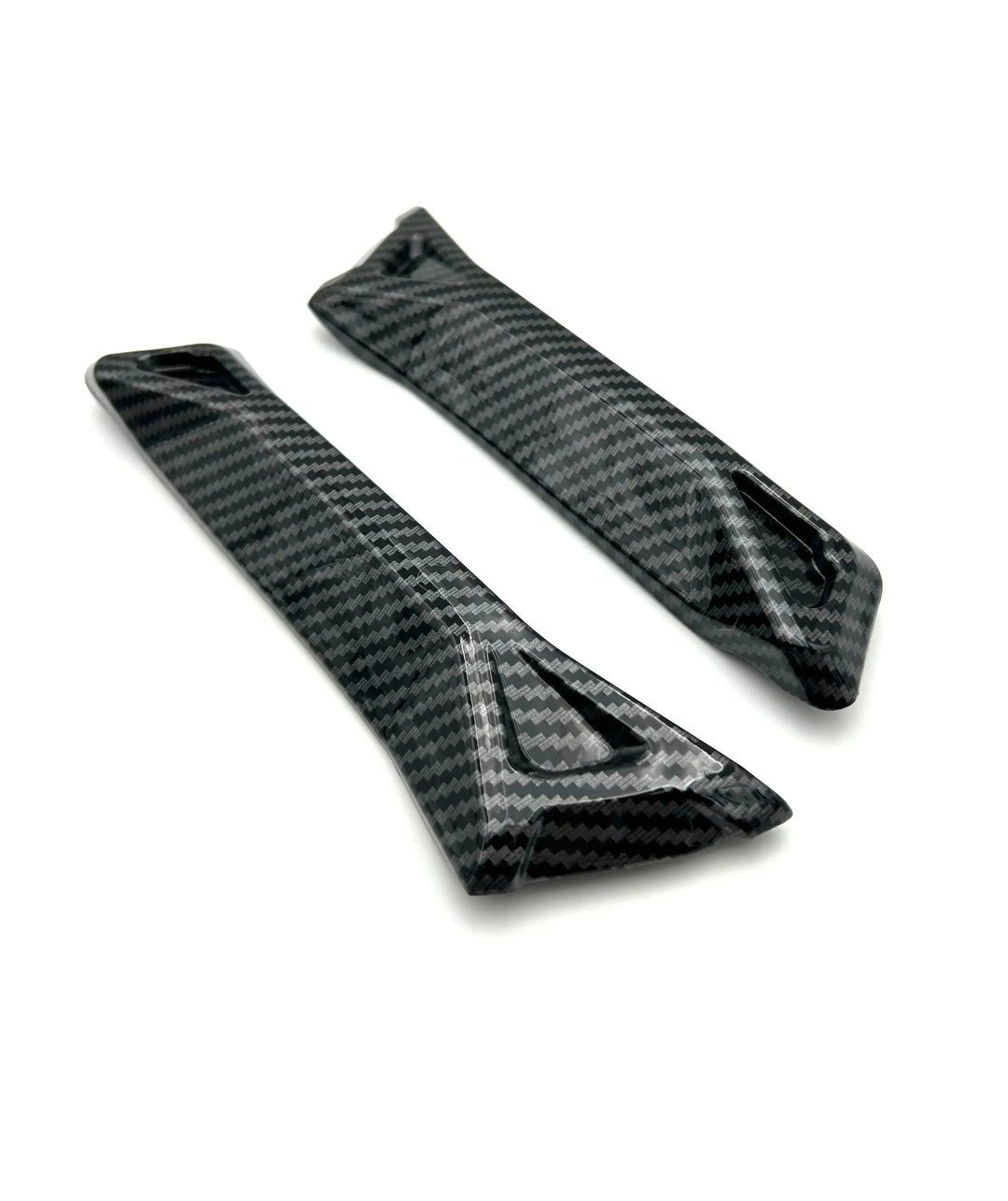 Two carbon fiber winglets on a white background