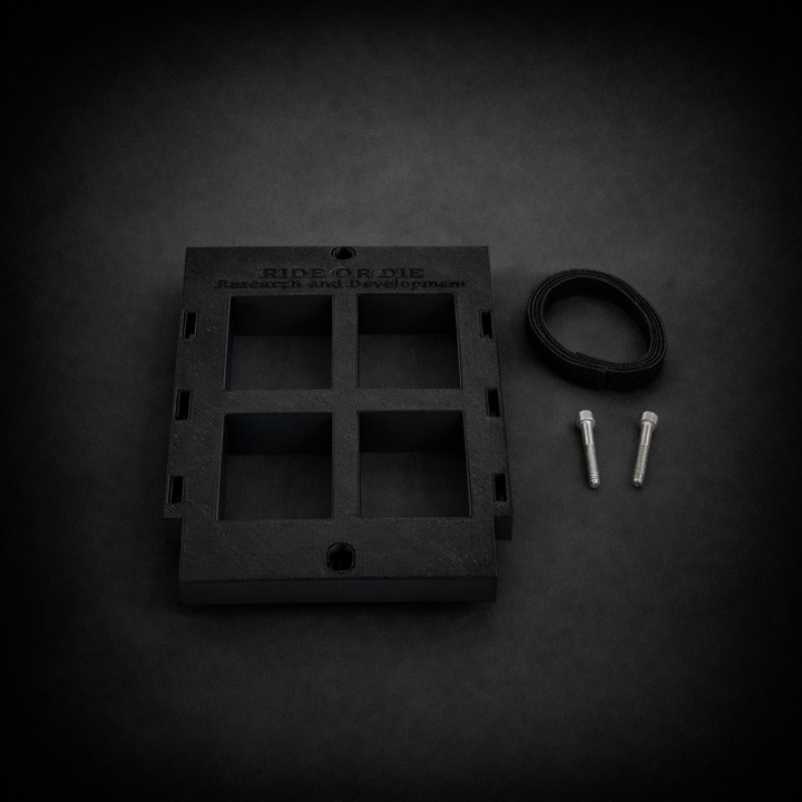 Black metal bracket with mounting hardware on a dark background