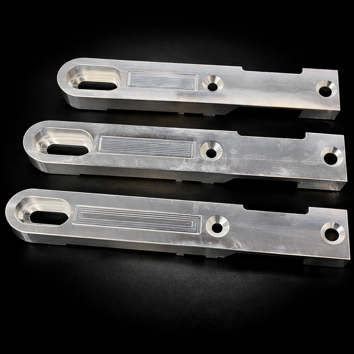 Three metallic brackets on a black background