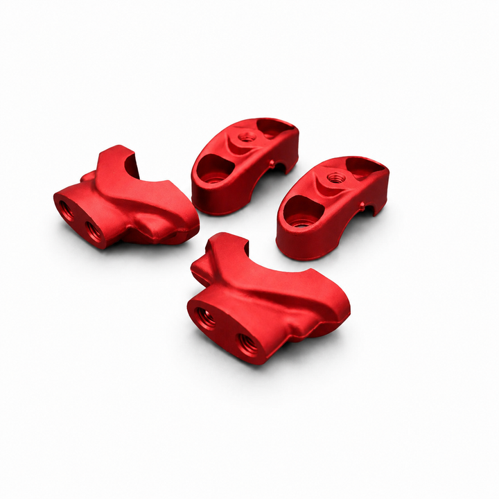 Four red metal components on a white background