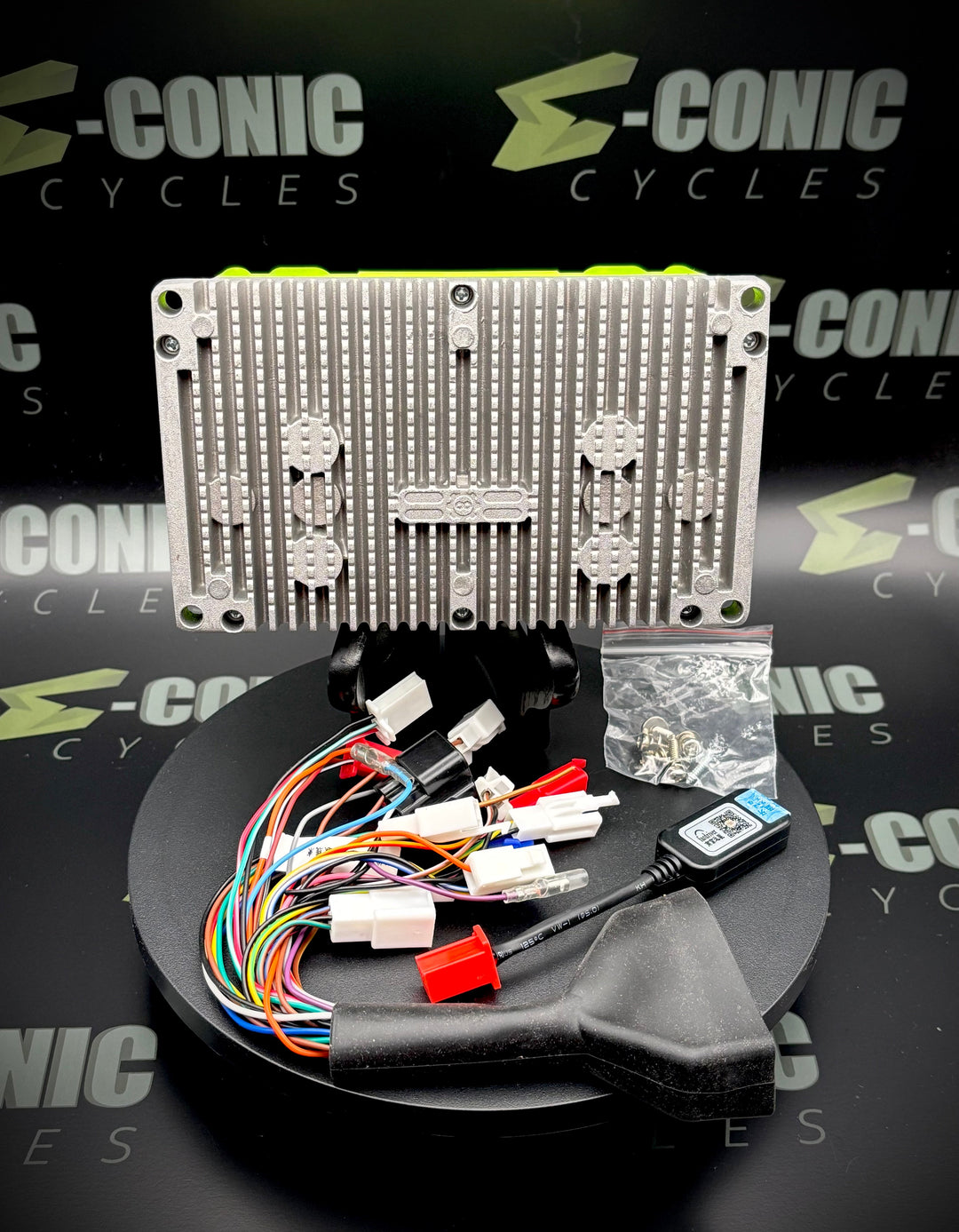 Electronic components and wiring on a stand with 'S-Conic Cycles' branding in the background.