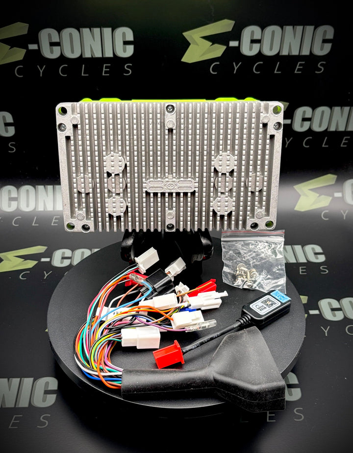 Electronic components and wiring on a stand with 'S-Conic Cycles' branding in the background.