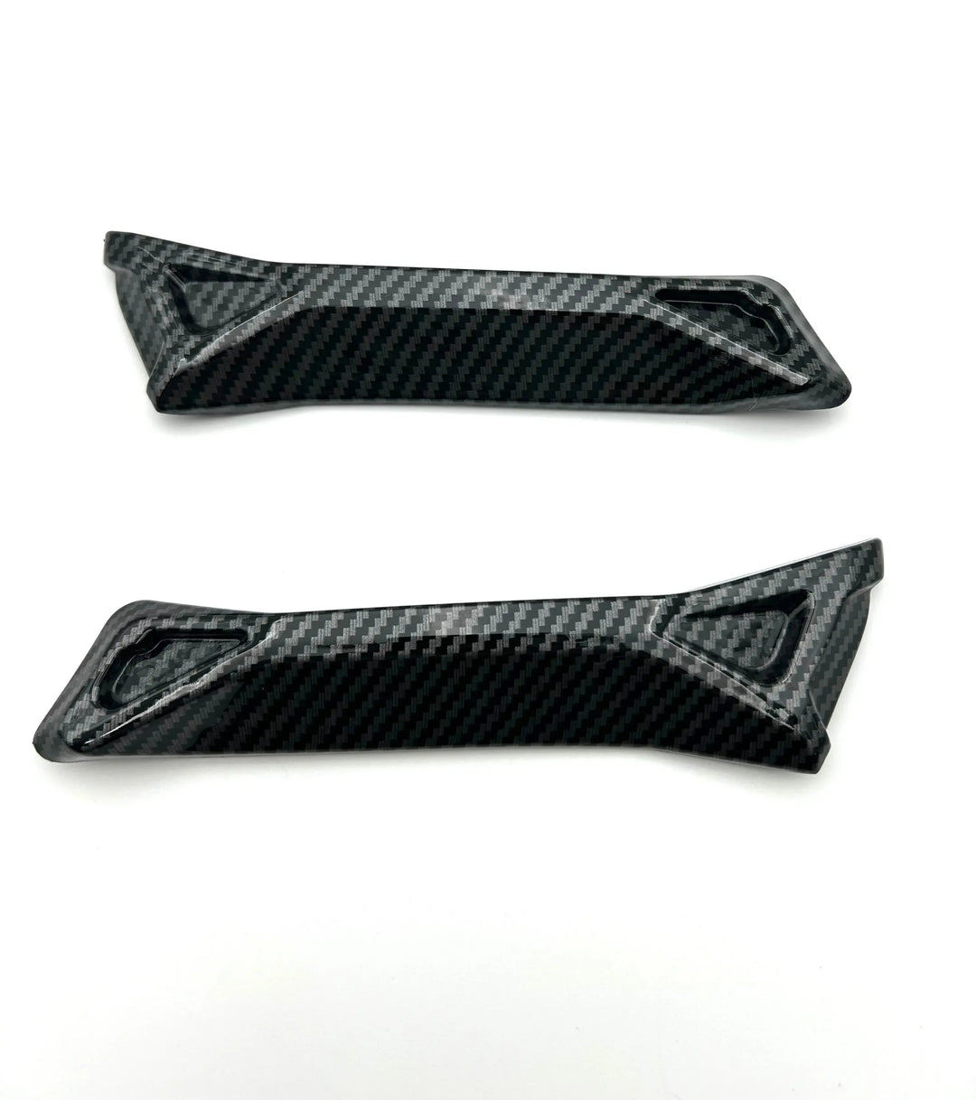 Two carbon fiber panels on a white background
