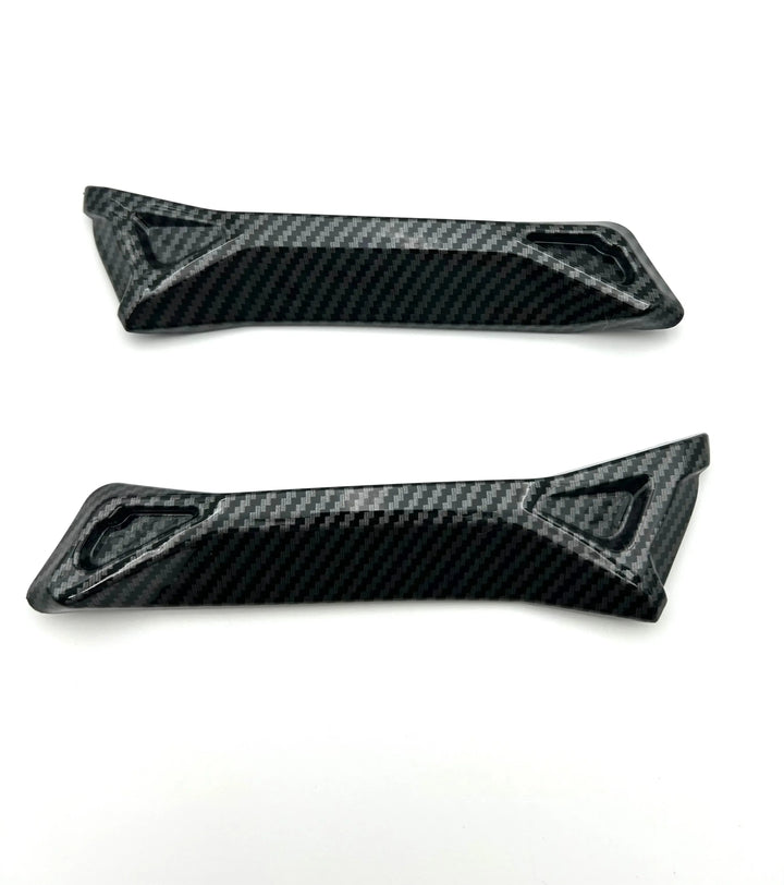 Two carbon fiber panels on a white background